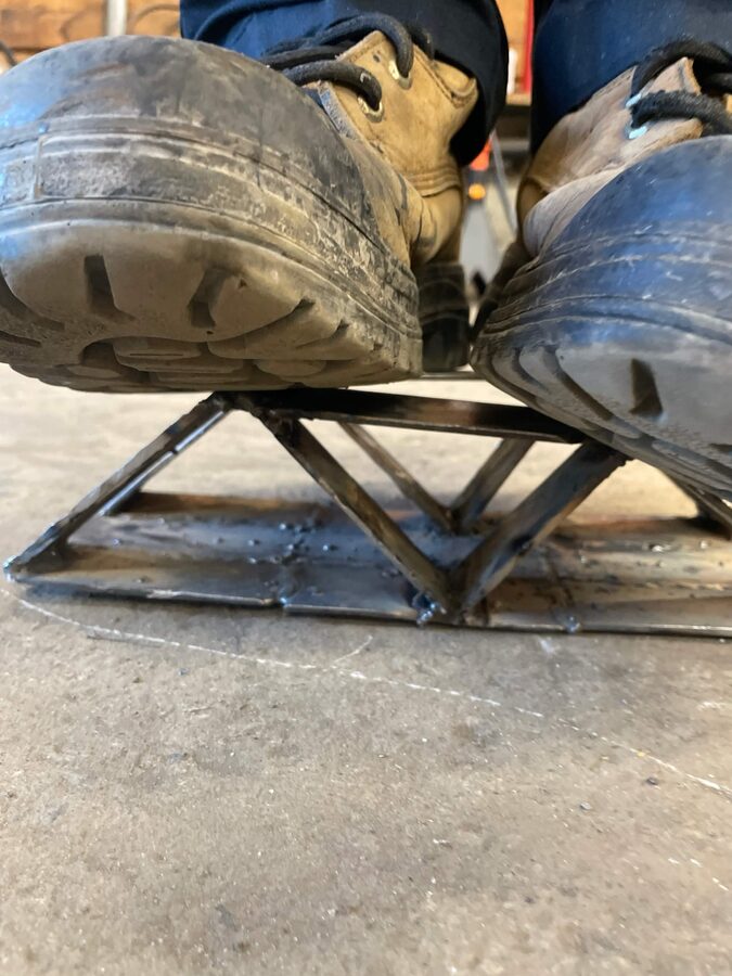 Fabricated steel truss holding body weight